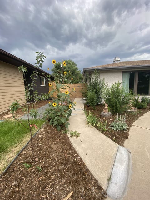 View of the walk-path leading the to the fence gate and the entrance to the unit