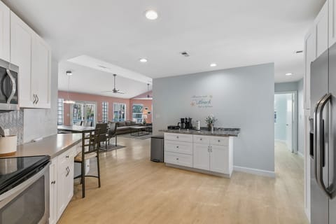 Fully equipped kitchen, dedicated work space, and coffee bar