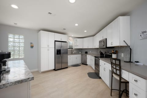Stainless steel appliances and fully equipped kitchen.