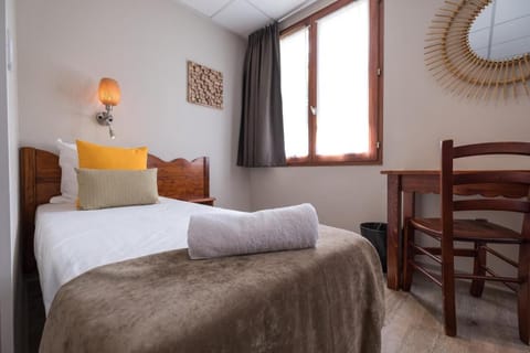 The room's bed and workspace.