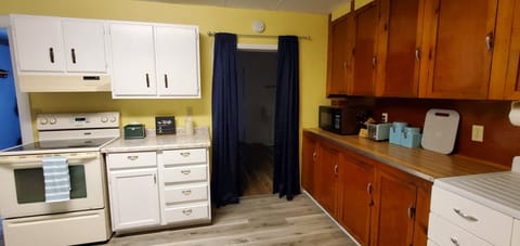 Spacious closet area is behind the curtain.   Large kitchen w/cooking essentials