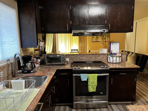 Kitchen - granite counters, radiant stove with oven, toaster oven, coffee maker