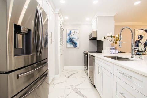 Kitchen area with all stainless steel appliances - microwave, dishwasher, range & refrigerator!