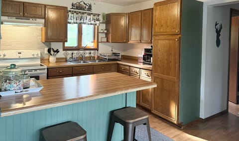 Kitchen with 2 stools to keep conversation going while preparing meals.