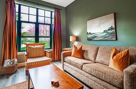 Living area with fire place, sofa bed and large LCD TV