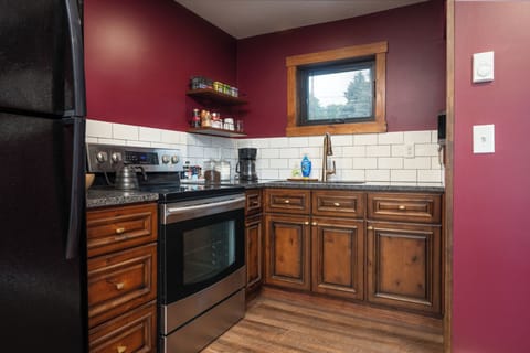 This full kitchen is stocked and ready—cookware, dishes, utensils, and even frozen pizzas for late-night cravings. Whether you're reheating leftovers or making breakfast from scratch, you’ll have everything you need just steps from the dining nook and balc