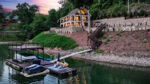Summer at Skipping Stones Getaway Backyard with hot tub, fire pit, wood, roasting forks, corn hole boards, picnic table