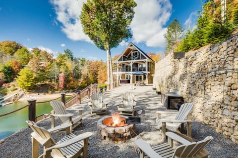 Fall at Skipping Stones Getaway Backyard with hot tub, fire pit, wood, roasting forks, corn hole boards, picnic table