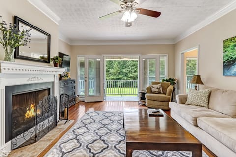 Living room leads out to wrap around porch and view of the yard