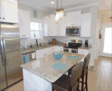 Well stocked kitchen with granite countertops and an island