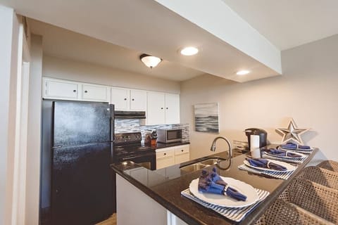 Fully stocked kitchen with appliances, pots/pans, dishes, toaster, blender