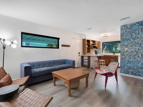 Living room has seating for 6 people. Mix of eclectic pieces make this room unique and special.