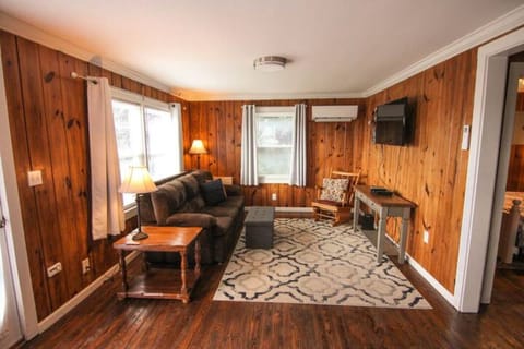 Living room with smart TV, board games stored in ottoman.