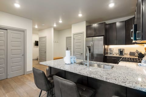 Full-sized kitchen with stainless steel appliances and granite countertops.