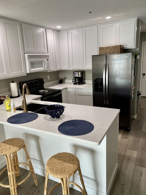 Remodeled kitchen with new sink, kitchen faucet & mini fridge