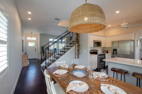 Dining table comfortably seats 6 plus 3 at the breakfast bar.