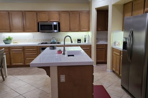 Open Kitchen with Island and Stainless steel Appliances. 