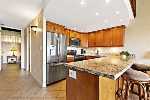 Beautifully remodeled kitchen featuring granite countertops and full size stainless steel appliances