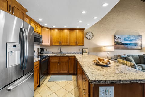Beautifully remodeled kitchen featuring granite countertops and full-size stainless steel appliances.