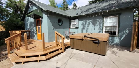 Rear deck with hot tub and string lights