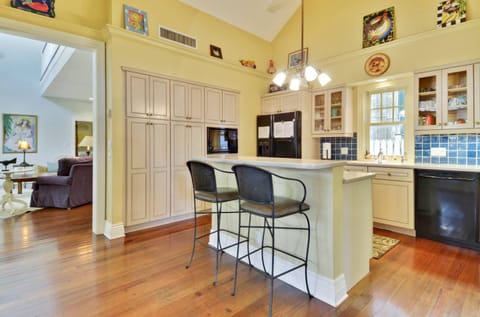 The kitchen features an island with breakfast bar seating.