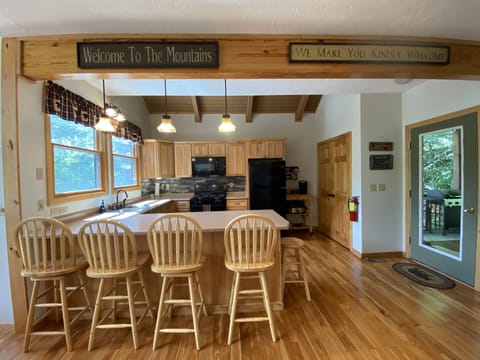 Open kitchen and breakfast bar provides eating space for 12+ for larger families