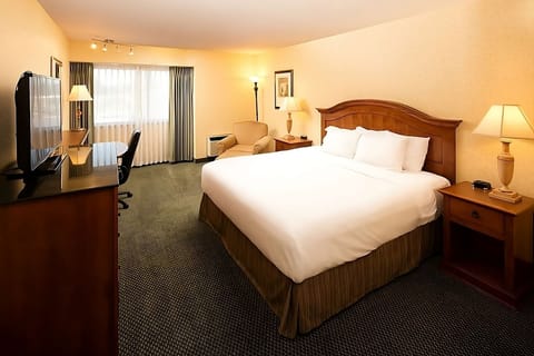 Unwind in a spacious king room with cozy seating.