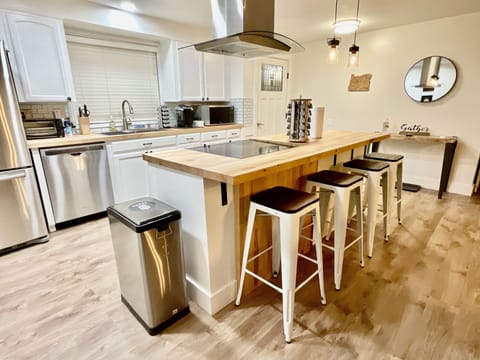 Kitchen is equipped with cooking essentials, olive oil, and an array of spices.