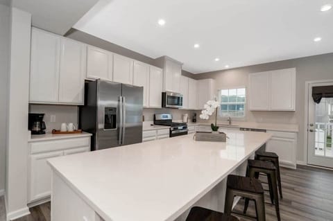 The large center island provides ample space for meal prep and casual dining, while the open floor plan allows for easy entertaining.