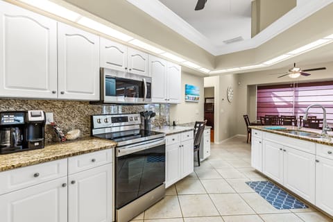 Range area in Kitchen with Desk area/work station on the far right of cabinets