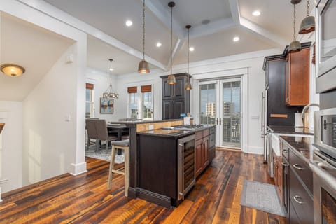Kitchen & Dining Room Blessed with the Warmth of Beautiful Hand Scraped Wood Floors & Natural Sunlight Filtered through Vaulted Ceilings with Wood Bea