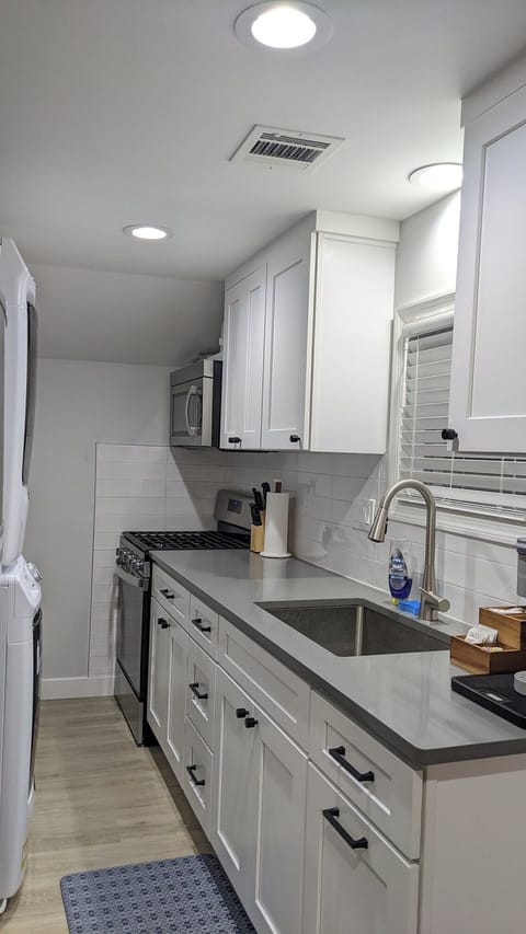 Fully outfitted kitchen includes stackable washer and dryer