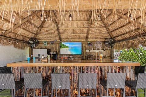 This tiki bar has entertainment with plenty of seating for the game