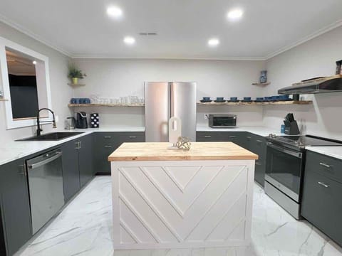Chef’s kitchen with stainless steel appliances and modern island.