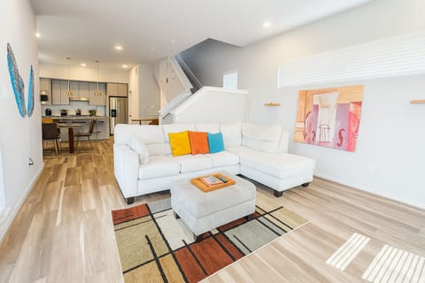 Step into a bright, open concept living space with plush sectional. 