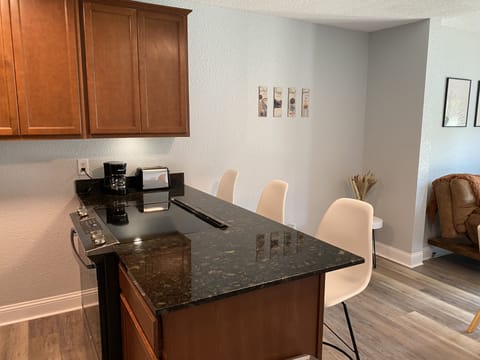 Kitchen area with 3 bar stools. Fulling stocked. With everything you need