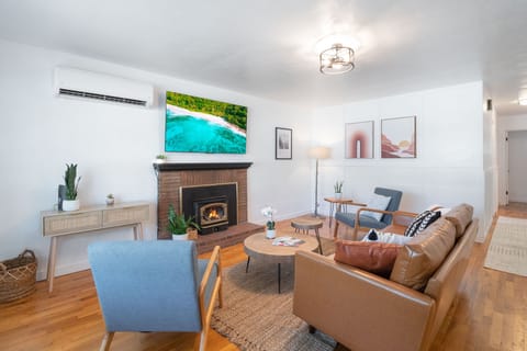 Spacious living room with a large 65” Smart TV, perfect for a fun movie night.