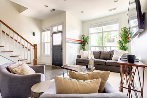 The cozy living room offers ample seating, perfect for engaging conversations with guests.