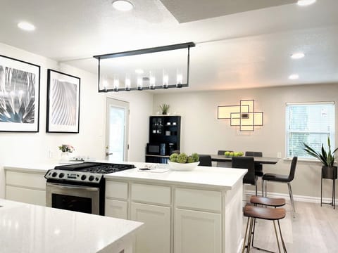 Open concept large kitchen island with quartz countertop and many seating.