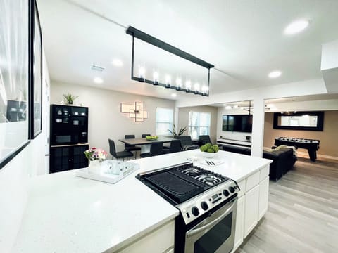 Open concept large kitchen island with quartz countertop and many seating.