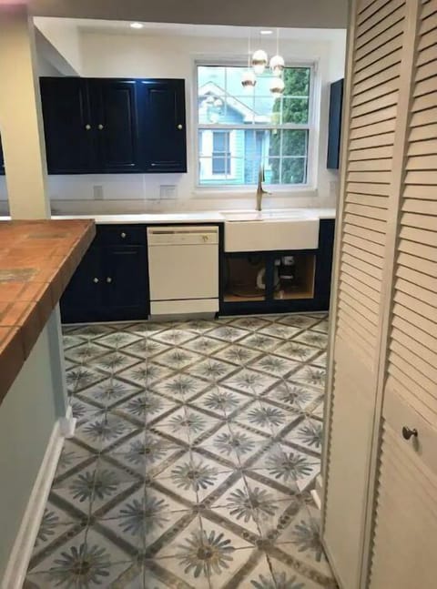 Dishwasher, farmers sink and Spanish tile accompany this gorgeous kitchen