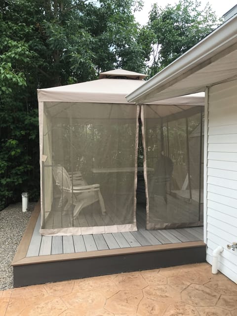 Screened Gazebo with chairs and table for bug free nights outside
