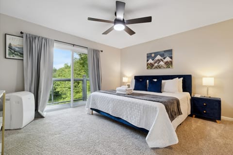 Master bedroom upstairs with king bed, Roku TV, and private balcony