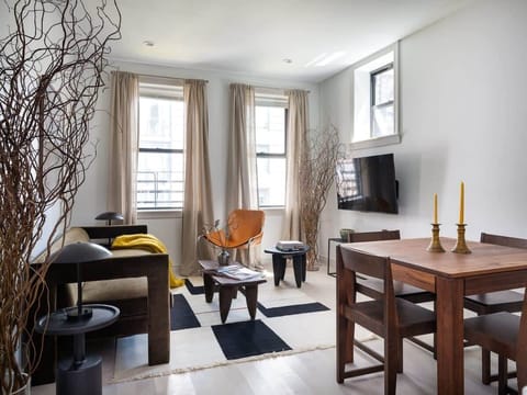 Living are with dining table and couch facing TV