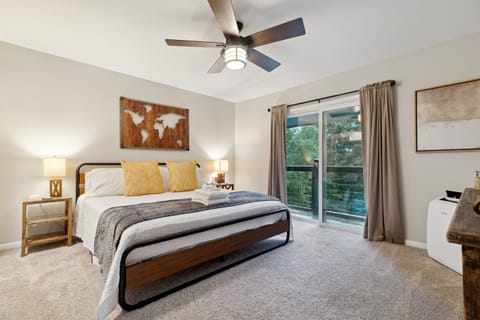 Master bedroom upstairs with king bed, Roku TV, and private balcony