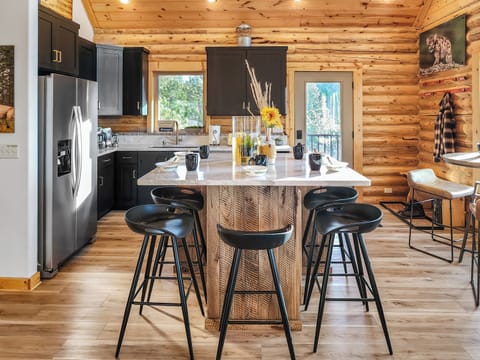 ...and the kitchen features additional island seating and a cafe table for two!