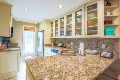 The kitchen features a dishwasher, range, refrigerator and microwave.