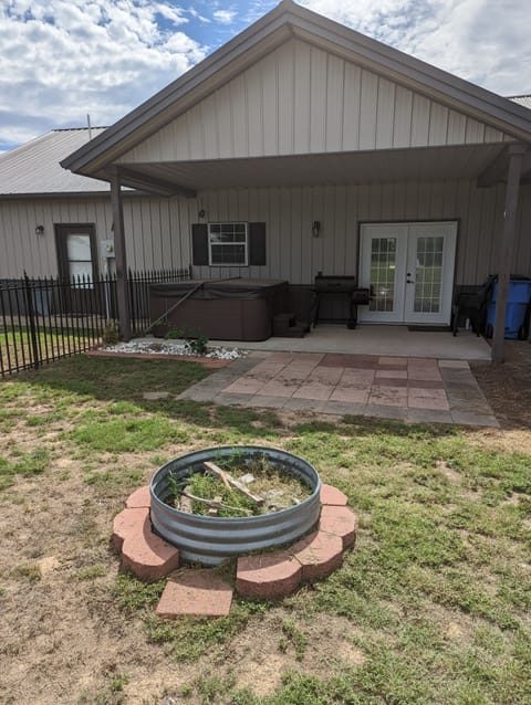 Back patio; hot tub, grill and fire pit.