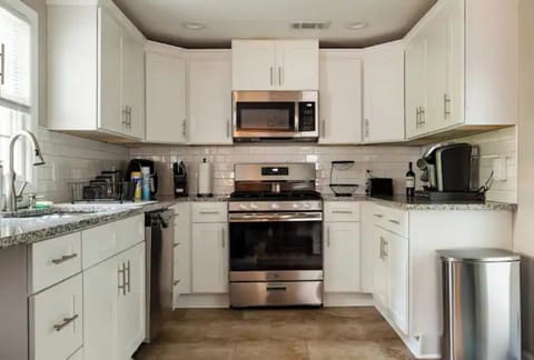 Kitchen comes complete with a microwave, dishes, utensils, and cooking supplies.