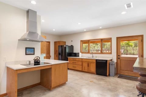 Golden woodwork glows in the ranch's full kitchen, making your food prep space both useful and pleasant to the eye!